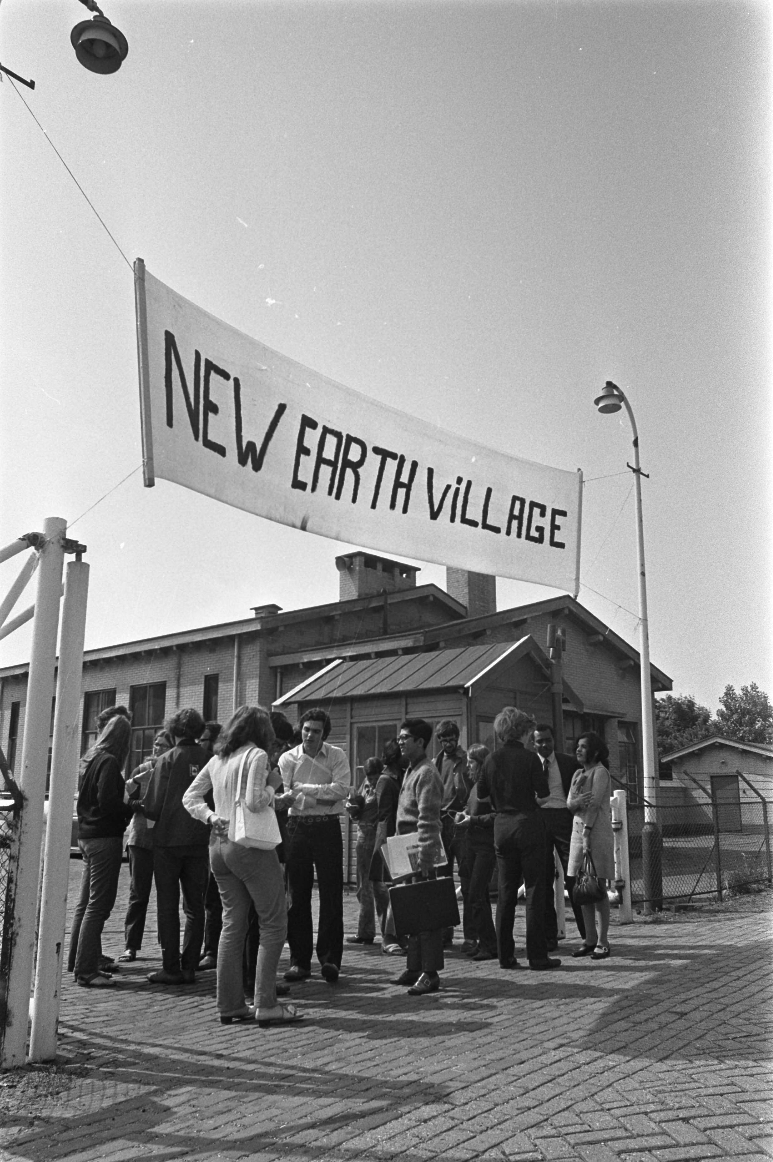 Fotocollectie Anefo — Internationaal Jeugdcongres ter voorbereiding i.v.m. FAO 2e Wereld Voedselcongres , in The New Earth , Den Haag jongeren in poort The new Earth praten / — Foto: Verhoeff, Bert / Anefo. Licentie: Set B: Rechtenvrij / Publiek Domein. Bron: Nationaal Archief. http://hdl.handle.net/10648/ab998564-d0b4-102d-bcf8-003048976d84