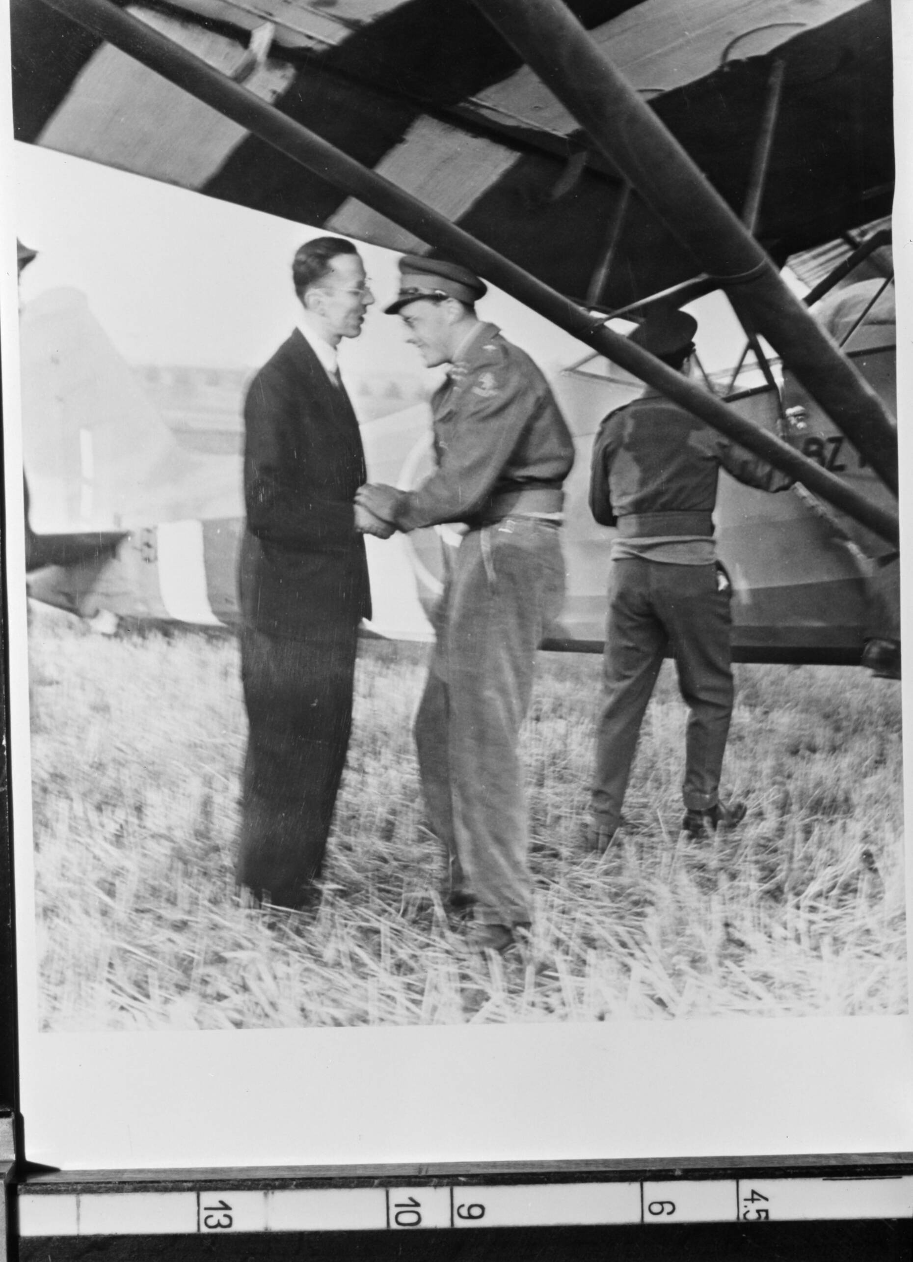 Reproductiefotografie — Foto van een foto gemaakt na de landing van Prins Bernhard bij de Bilserbaan bij Maastricht. Prins Bernhard wordt begroet door Willem Baron Michiels van Kessenich, burgemeester van Maastricht — Foto: Poll, Willem van de. Licentie: Set B: Rechtenvrij / Publiek Domein. Bron: Nationaal Archief. http://hdl.handle.net/10648/aeab3b12-d0b4-102d-bcf8-003048976d84
