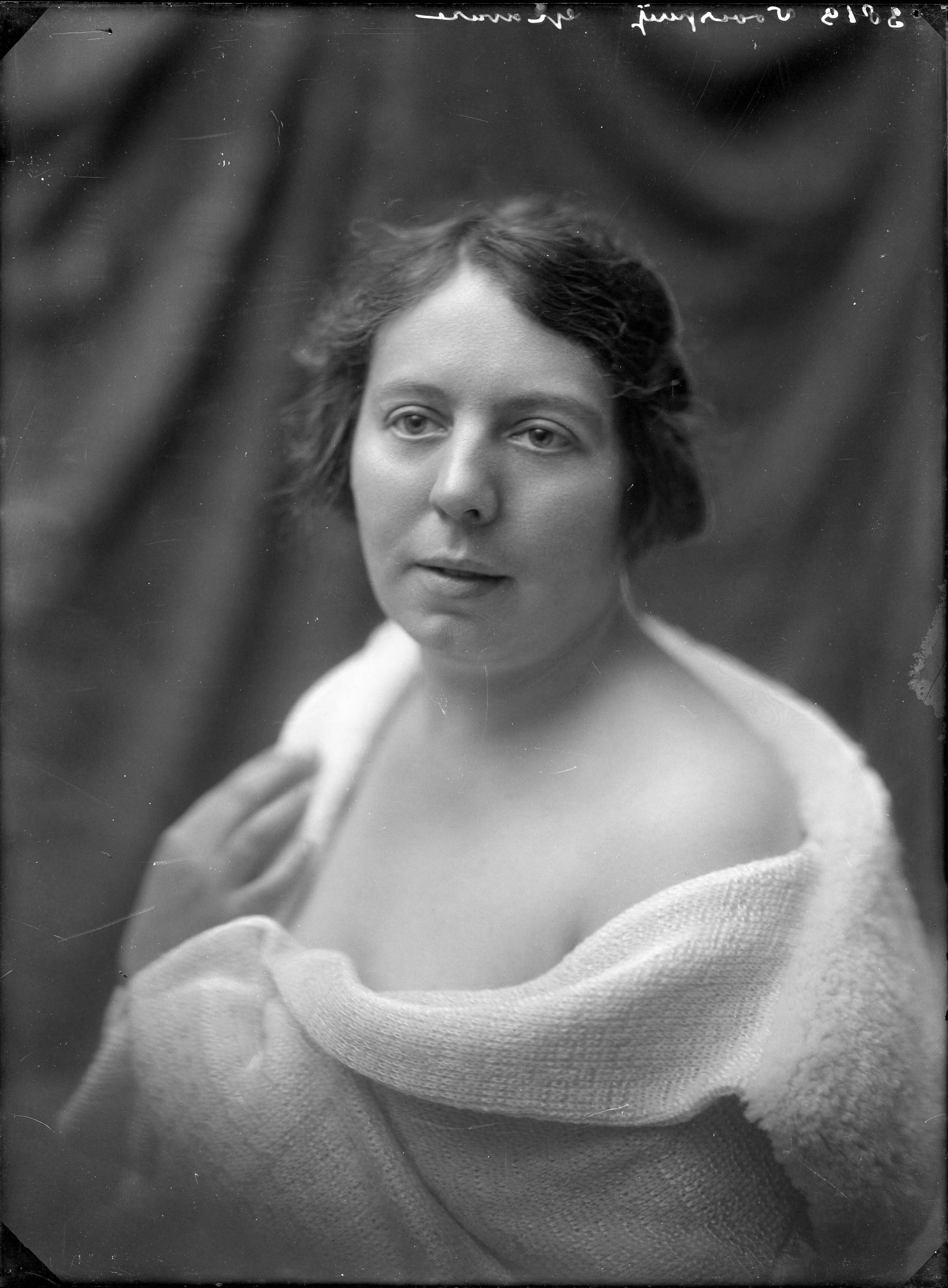 Portretten, "Leeftijdsgroepen (jong, middelbaar, oud)" — Studio-opnames. Portret van een vrouw met recht geknipt oorlang haar, met een badjas over haar blote schouders gedrapeerd. 3819 Voorsperij ('per'moeilijk leesbaar) gravure — Foto: Berg, Th.C.J. van den / Spaarnestad Photo (05887). Licentie: Set B: Rechtenvrij / Publiek Domein. Bron: Nationaal Archief. http://hdl.handle.net/10648/35429da7-c61d-a382-e063-6df0900a6686