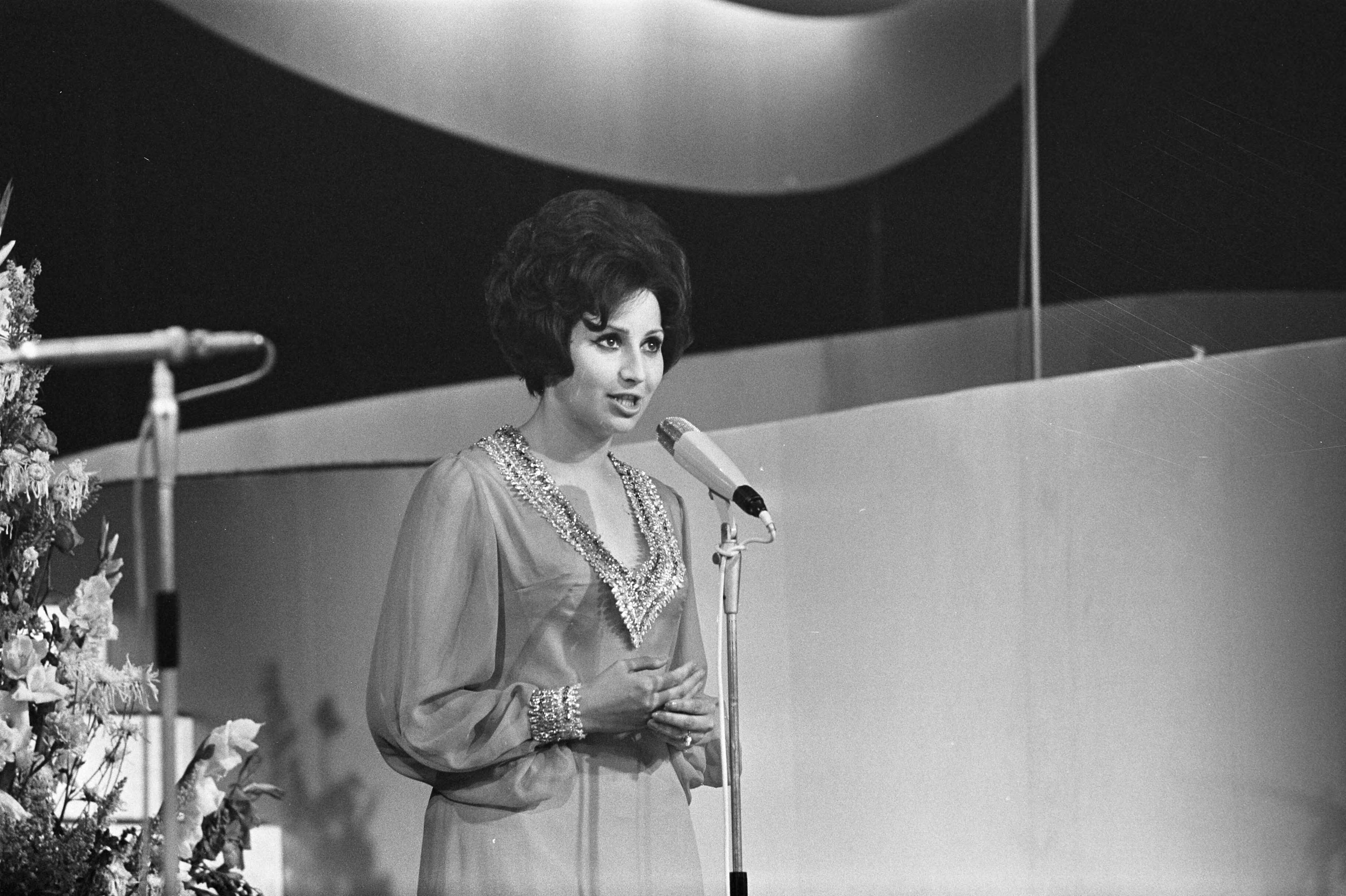 Singing Europe 1969, de finale in Scheveningen — Presentatrice Helga Vlahovic — Foto: Fotograaf Onbekend / Anefo. Licentie: Set B: Rechtenvrij / Publiek Domein. Bron: Nationaal Archief. http://hdl.handle.net/10648/ab724012-d0b4-102d-bcf8-003048976d84