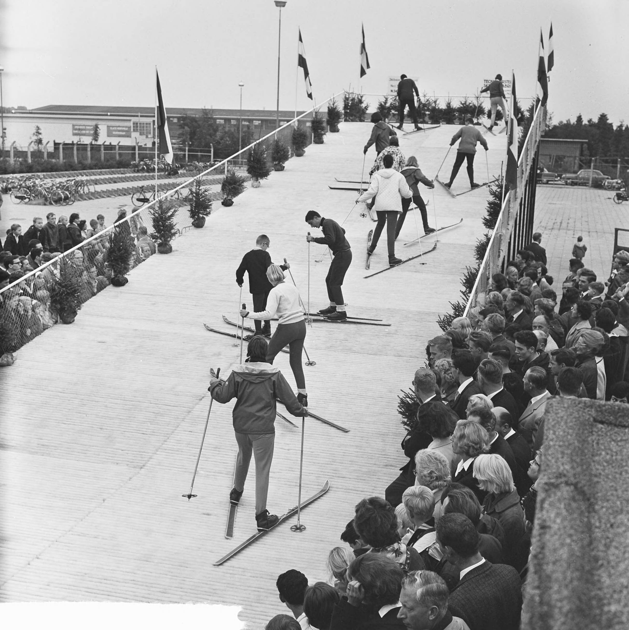 Fotocollectie Anefo — Kunstskibaan in Hilversum geopend door burgemeester J.J.G. Boot. Na de opening beklimmen skiërs de baan — Foto: Koch, Eric / Anefo. Licentie: Set B: Rechtenvrij / Publiek Domein. Bron: Nationaal Archief. http://hdl.handle.net/10648/aa464508-d0b4-102d-bcf8-003048976d84