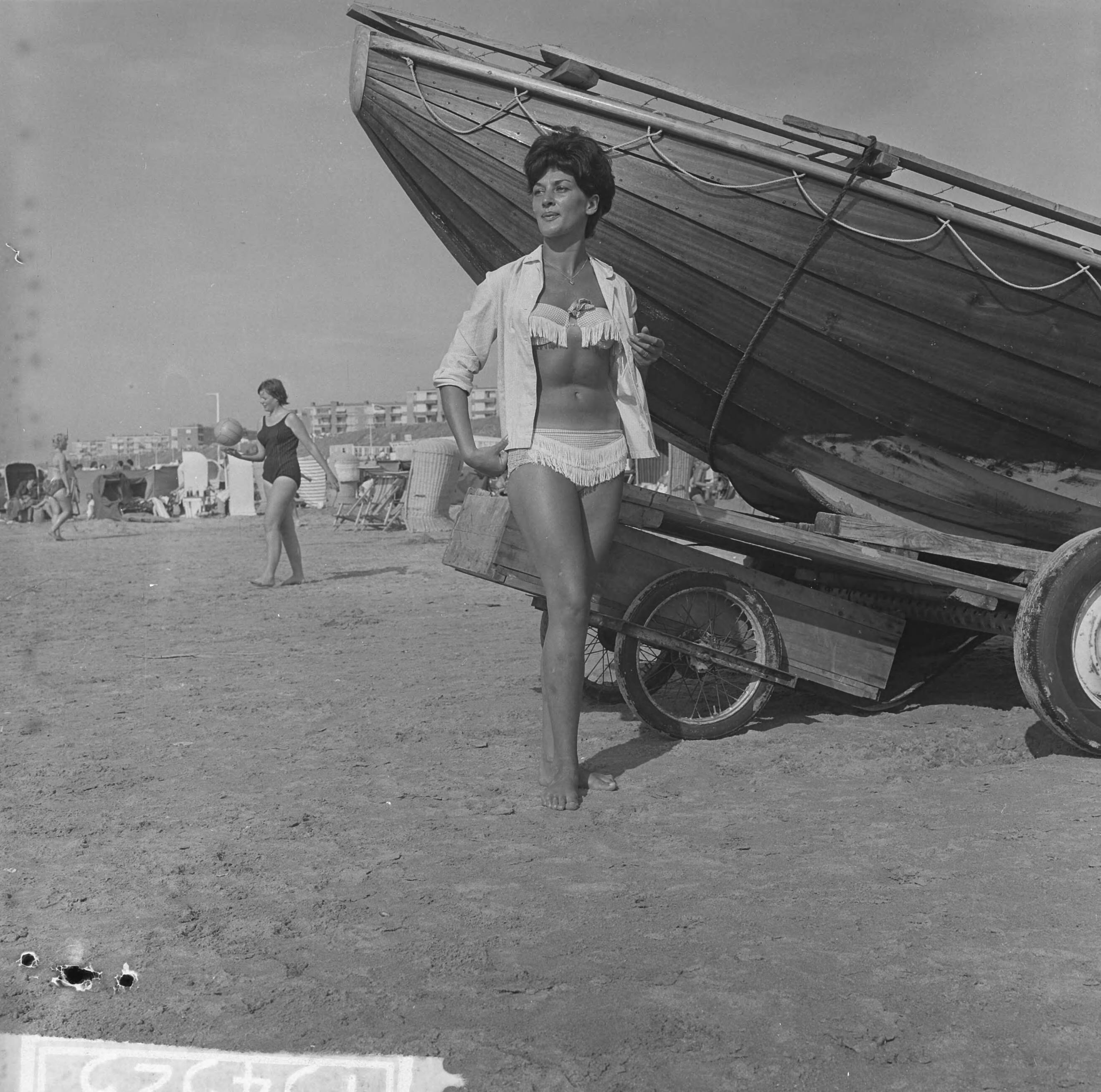 Fotocollectie Anefo — Strandmode 1963 in praktijk op het Zandvoortse strand. In bikini — Foto: Koch, Eric / Anefo. Licentie: Set B: Rechtenvrij / Publiek Domein. Bron: Nationaal Archief. http://hdl.handle.net/10648/aa42a42a-d0b4-102d-bcf8-003048976d84