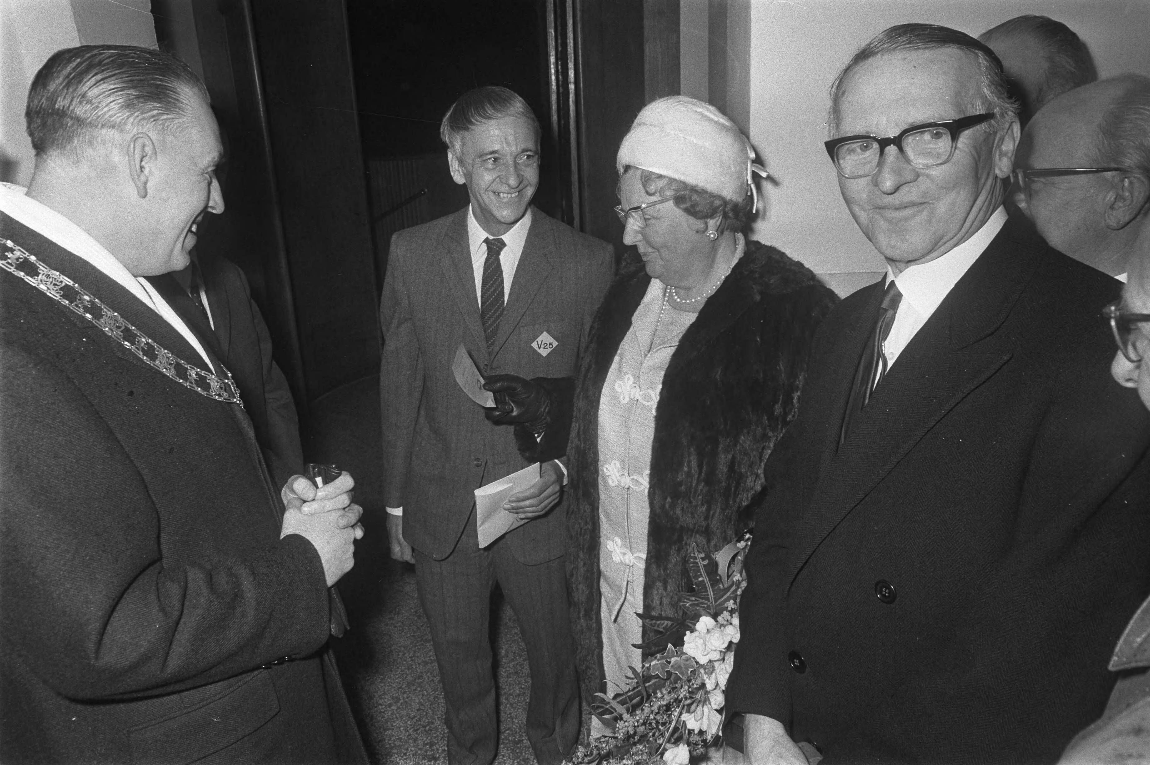 Herdenking in Leeuwarden van 25 jaar bevrijding van Friesland in aanwezigheid van koningin Juliana — Koningin Juliana ontvangt in het beursgebouw van Leeuwarden van de heer Hallema een 'Ausweiss'. Links burgemeester van Leeuwarden Brandsma — Foto: Fotograaf Onbekend / Anefo. Licentie: Set B: Rechtenvrij / Publiek Domein. Bron: Nationaal Archief. http://hdl.handle.net/10648/ab943adc-d0b4-102d-bcf8-003048976d84