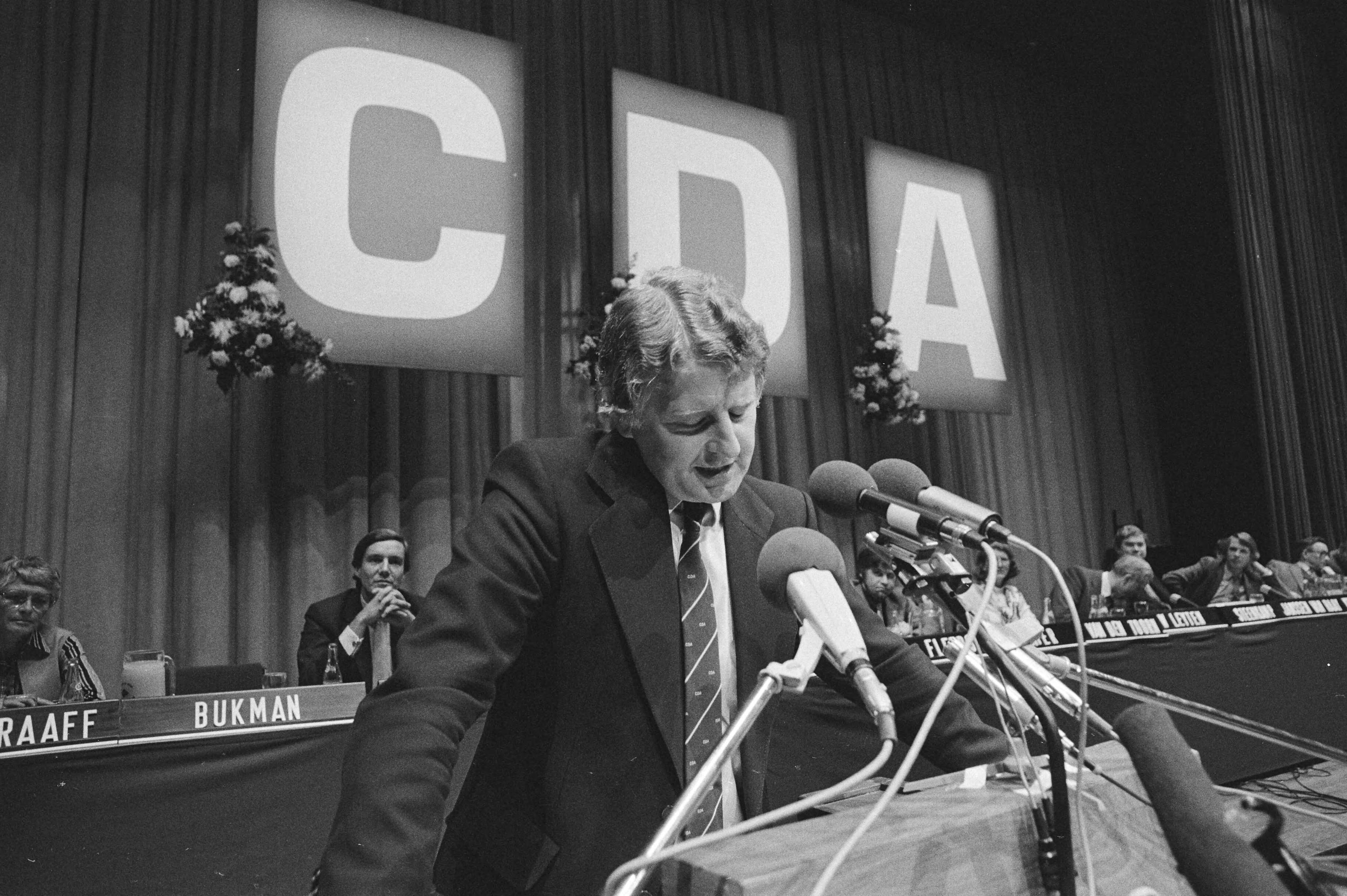 Fotocollectie Anefo — Fusie congres CDA in Den Haag , nieuwe CDA-voorzitter Bukman aan het woord — Foto: Antonisse, Marcel / Anefo. Licentie: Set B: Rechtenvrij / Publiek Domein. Bron: Nationaal Archief. http://hdl.handle.net/10648/acea8b52-d0b4-102d-bcf8-003048976d84