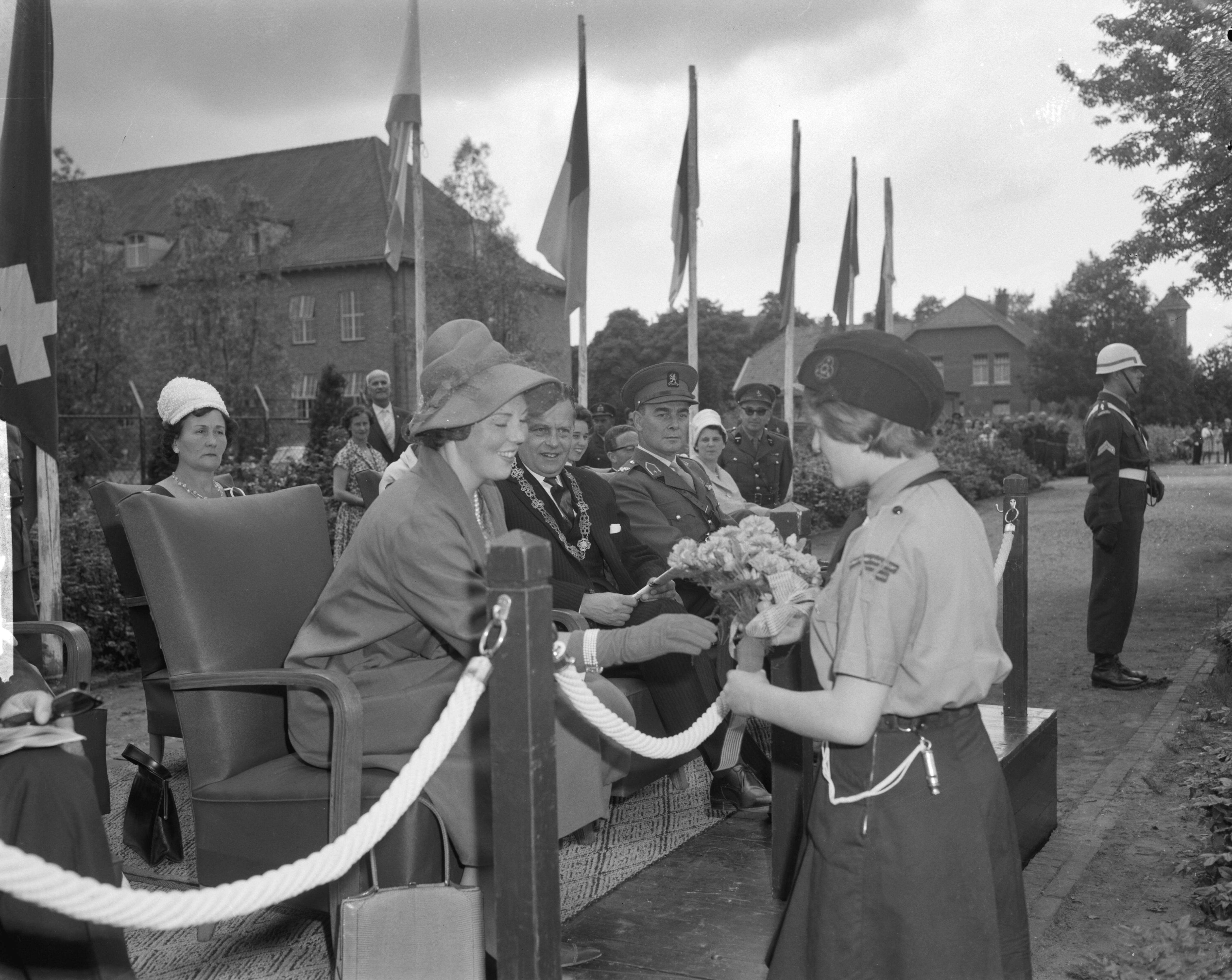 Fotocollectie Anefo — Prinses Beatrix poliomars in Breda, wandelaars defileren voor prinses Beatrix. De prinses, met naast zich n burgemeester van Breda, mr. R.M.A.A.Geuljans [en een brigade-generaal] ontvangt bloemen van de 13-jarige Yvonne Hakkaart — Foto: Bilsen, Joop van / Anefo. Licentie: Set B: Rechtenvrij / Publiek Domein. Bron: Nationaal Archief. http://hdl.handle.net/10648/aa0cb914-d0b4-102d-bcf8-003048976d84