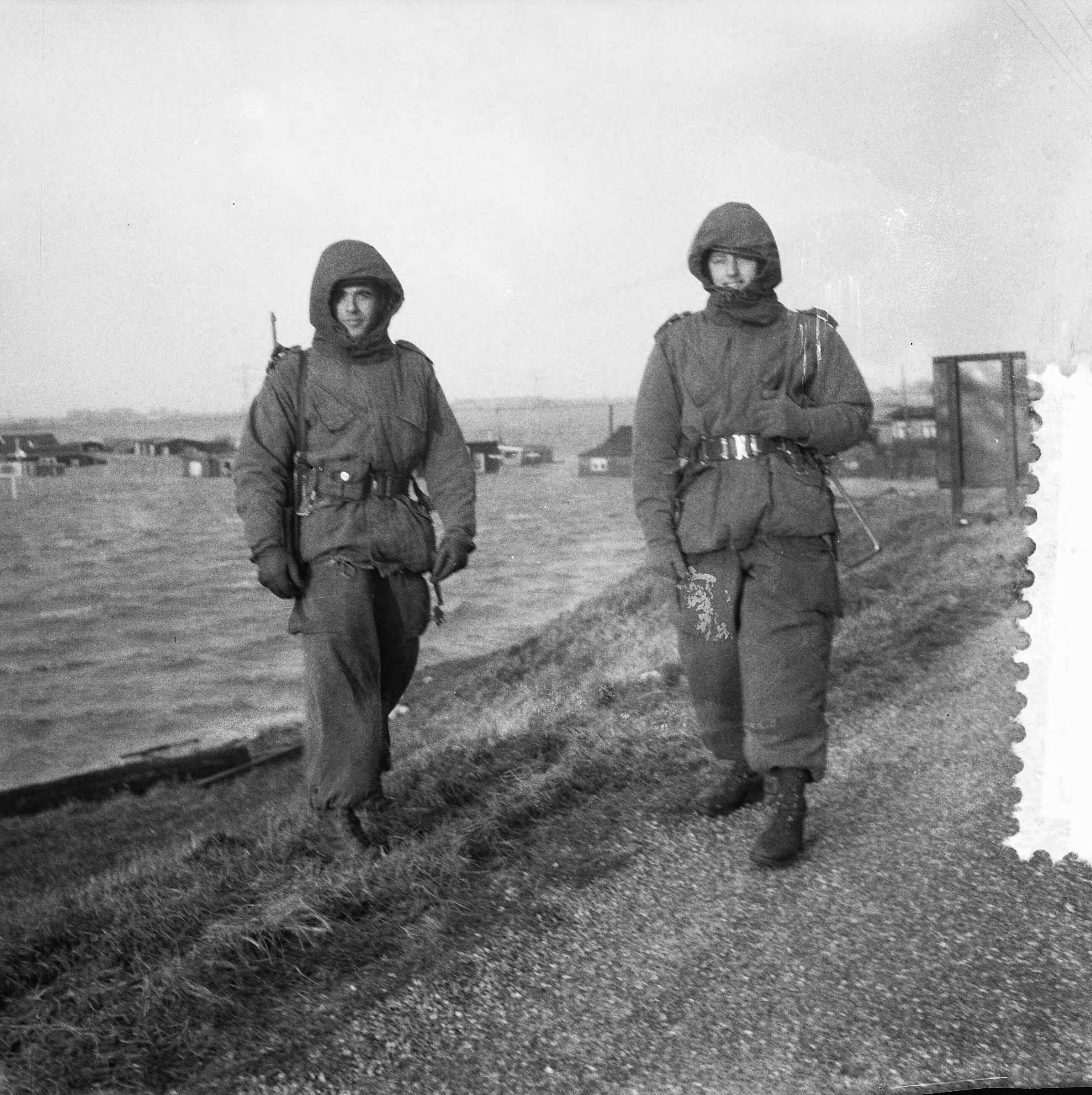 Ramp Tuindorp Oostzaan — Ramp Tuindorp Oostzaan. Twee bewapende militairen op een dijk bij het overstromingsgebied — Foto: Lindeboom, Henk / Anefo. Licentie: Set B: Rechtenvrij / Publiek Domein. Bron: Nationaal Archief. http://hdl.handle.net/10648/a9a63612-d0b4-102d-bcf8-003048976d84