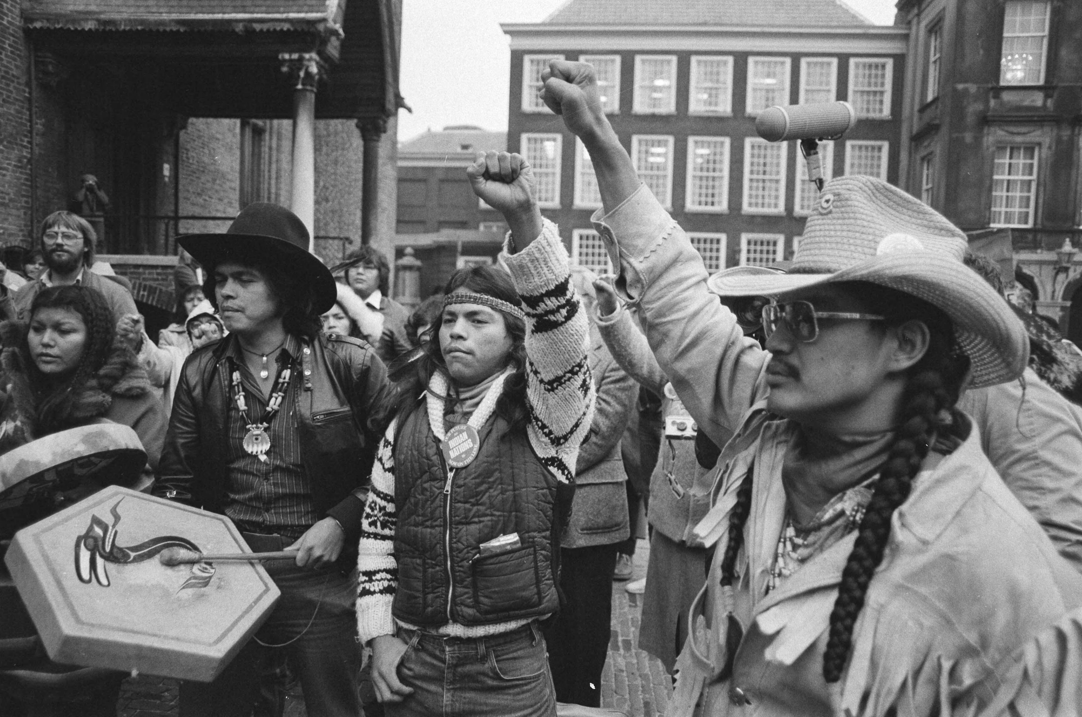 Groep Canadese Indianen demonstreert op het Binnenhof in Den Haag, teneinde aandacht te verkrijgen voor de situatie in hun land — Den Haag|Zuid-Holland|indianen |demonstraties — Foto: Antonisse, Marcel / Anefo. Licentie: Set B: Rechtenvrij / Publiek Domein. Bron: Nationaal Archief. http://hdl.handle.net/10648/ad088e7c-d0b4-102d-bcf8-003048976d84