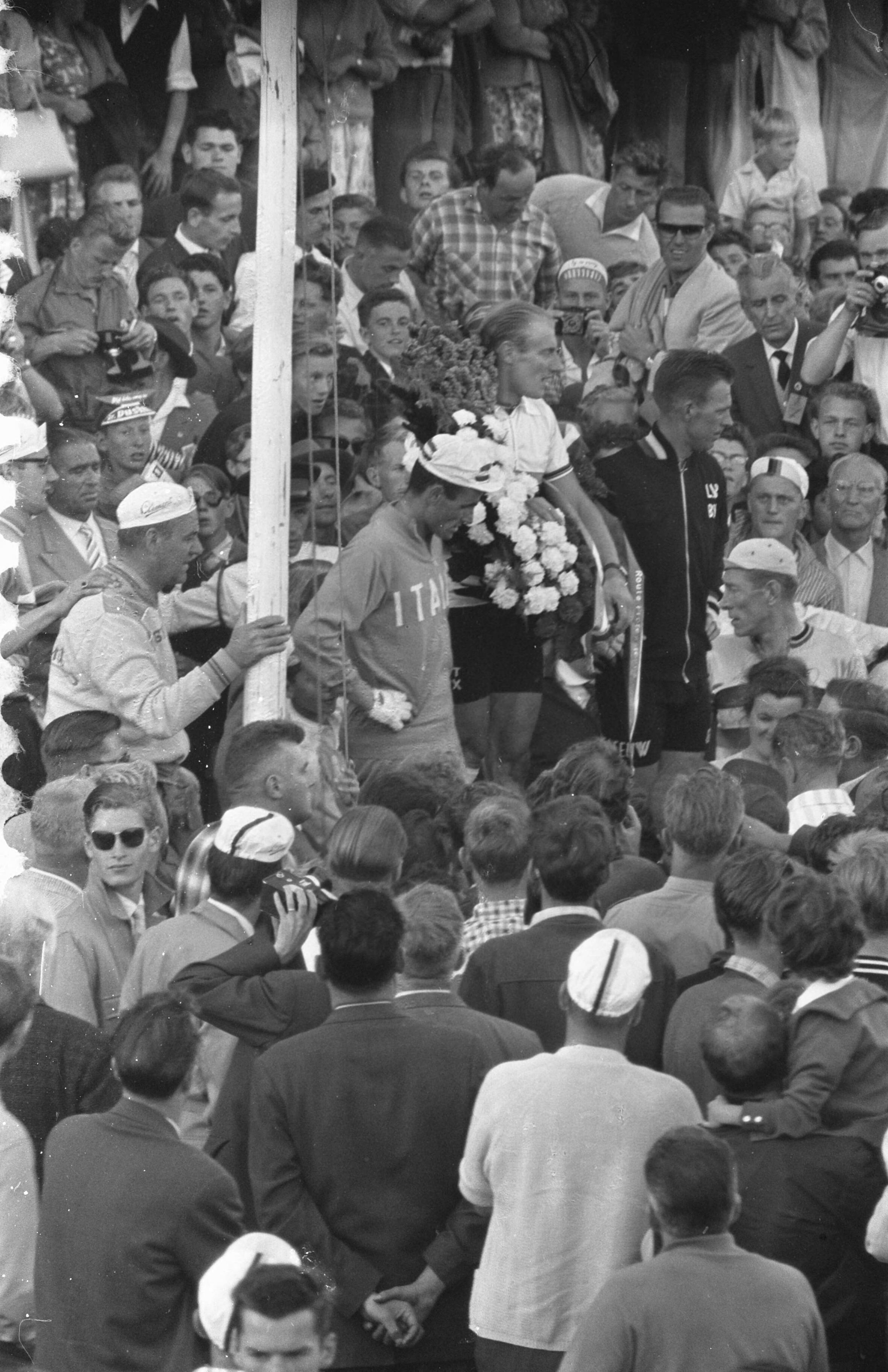 Fotocollectie Anefo — Wereldkampioenschappen wielrennen voor profs op de weg in Zandvoort. Huldiging van winnaar André Darrigade (rechts). Links de Italiaan Michelle Gismondi, die 2e werd, en rechts de Belg Noel Fore (3e) — Foto: Rossem, Wim van / Anefo. Licentie: Set B: Rechtenvrij / Publiek Domein. Bron: Nationaal Archief. http://hdl.handle.net/10648/a99b4978-d0b4-102d-bcf8-003048976d84