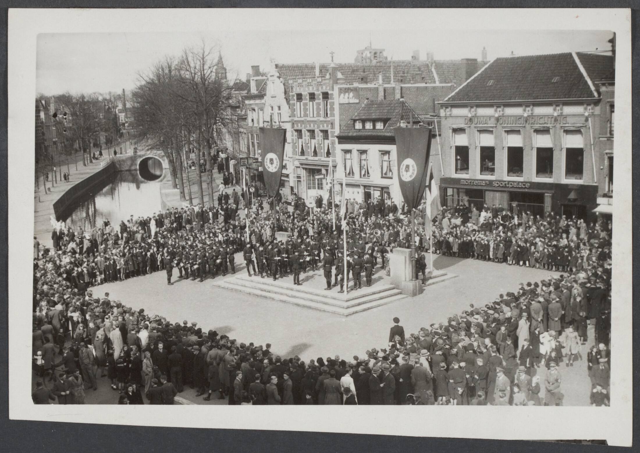 Arbeidsdienst. Waaronder "Nederlandse Arbeidsdienst" en "Vreugde en Arbeid" ("Fut door lol" 81). Ook opbouwdienst 1940/41. — In Leeuwarden werd een bijeenkomst gehouden van verschillende afdelingen van de Nederlandse Arbeidsdienst, waar de Rijkscommissaris, Rijksminister dr. Seyss-Inquart en de nieuw benoemde commandant van de Nederlandse Arbeidsdienst, generaal arbeidsleider L.A.C. de Bock, een rede heilden. On belangstelling van het publiek werd door het Ataf-orkest van de Nederlandse Arbeidsdienst een concert gegeven — Foto: Zeylemaker, J. / Centraal Nederlandsch Fotopersbureau [CNF]. Licentie: Set B: Rechtenvrij / Publiek Domein. Bron: Nationaal Archief. http://hdl.handle.net/10648/a5caa0a8-0d2f-c59e-4809-fceb37efc74b