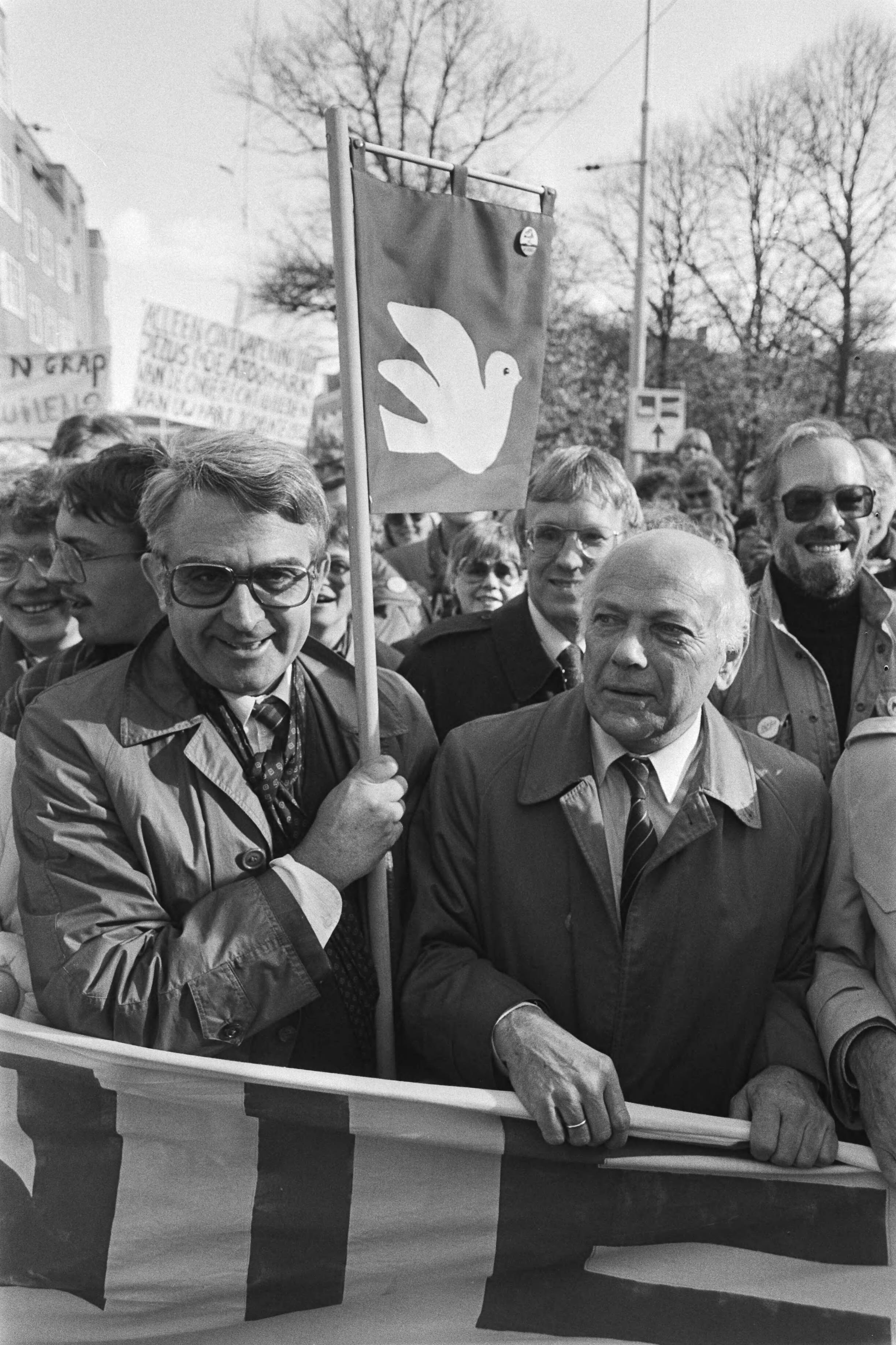 Vredesdemonstratie Den Haag , 550.000 mensen demonstreren o.m. tegen plaatsing kruisrakette — Jan Nico Scholten (CDA) met vredesvlag en dhr. Den Uyl (PvdA) — Foto: Antonisse, Marcel / Anefo. Licentie: Set B: Rechtenvrij / Publiek Domein. Bron: Nationaal Archief. http://hdl.handle.net/10648/ad2fdd6a-d0b4-102d-bcf8-003048976d84